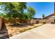 A private backyard features mature trees and block fencing at 8341 W Cypress St, Phoenix, AZ 85037