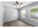 Bedroom featuring gray walls, neutral carpet and two windows with green outdoor views at 8341 W Cypress St, Phoenix, AZ 85037