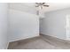 Bedroom featuring gray walls, neutral carpet, ceiling fan, and a door to the outside at 8341 W Cypress St, Phoenix, AZ 85037