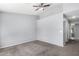 Spacious bedroom with gray walls, ceiling fan and neutral carpet throughout at 8341 W Cypress St, Phoenix, AZ 85037