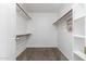 Walk-in closet with carpet flooring and hanging racks for clothing storage at 8341 W Cypress St, Phoenix, AZ 85037