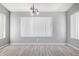 Dining room features neutral gray paint, white blinds, and wood-look tile floors at 8341 W Cypress St, Phoenix, AZ 85037
