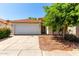 Charming single story home with a two-car garage and a well-maintained front yard and a red tile roof at 8341 W Cypress St, Phoenix, AZ 85037