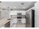 Modern kitchen features stainless steel appliances, granite countertops, and white cabinetry at 8341 W Cypress St, Phoenix, AZ 85037