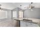 Bright eat-in kitchen area with granite counters, tile floors and stainless steel refrigerator at 8341 W Cypress St, Phoenix, AZ 85037