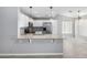 Modern kitchen with granite countertops, stainless steel appliances, and a breakfast bar open to the living space at 8341 W Cypress St, Phoenix, AZ 85037