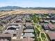 Expansive aerial view of a community with lush green spaces and mountain views at 880 S 150Th Dr, Goodyear, AZ 85338