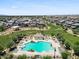 Aerial view of the community featuring a pool, playground, green spaces, and well-maintained homes at 880 S 150Th Dr, Goodyear, AZ 85338
