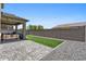 Well-maintained backyard featuring a covered patio, lush artificial turf, and neatly arranged gravel at 880 S 150Th Dr, Goodyear, AZ 85338