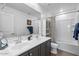 Bright bathroom featuring double sinks, large mirror and shower/tub combination with tiled walls at 880 S 150Th Dr, Goodyear, AZ 85338