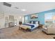 Spacious bedroom with a queen bed, sitting area and a beautiful blue accent wall with modern furnishings at 880 S 150Th Dr, Goodyear, AZ 85338