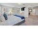 Inviting bedroom featuring plush carpet, a cozy bed, and ample natural light with a connecting office at 880 S 150Th Dr, Goodyear, AZ 85338