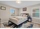 Cozy bedroom with natural light and a dark wood bed frame, complemented by a stylish rug at 880 S 150Th Dr, Goodyear, AZ 85338