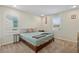 Cozy bedroom with a bed, carpeted floor, two windows, and simple decor for a calm setting at 880 S 150Th Dr, Goodyear, AZ 85338