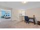 Upstairs bonus room featuring a desk, chair, carpeted floors and access to a secondary bedroom at 880 S 150Th Dr, Goodyear, AZ 85338