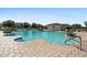 Community pool surrounded by lounge chairs and palm trees, ideal for relaxation at 880 S 150Th Dr, Goodyear, AZ 85338