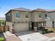 Two-story home with a two-car garage, stone accents, and a well-manicured front yard at 880 S 150Th Dr, Goodyear, AZ 85338