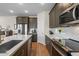 Modern kitchen with stainless steel appliances, white quartz counters, tile backsplash, and sleek gray cabinets at 880 S 150Th Dr, Goodyear, AZ 85338