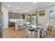Modern kitchen with stainless steel appliances, white quartz counters, and a dining area at 880 S 150Th Dr, Goodyear, AZ 85338