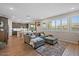 Bright living room with comfortable seating, wood-look tile flooring, and lots of natural light at 880 S 150Th Dr, Goodyear, AZ 85338