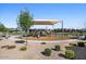 Community playground featuring shaded play equipment and a circular walking path at 880 S 150Th Dr, Goodyear, AZ 85338