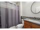 Bathroom with shower and tub combination, wood vanity, granite counters and modern fixtures at 9262 E Desert Park Dr, Scottsdale, AZ 85255