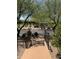 View of community park with benches, walking paths, and ramadas, framed by lush trees and a decorative iron fence at 9262 E Desert Park Dr, Scottsdale, AZ 85255