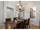 Elegant dining room with a chandelier, wood table, and bright window at 9262 E Desert Park Dr, Scottsdale, AZ 85255