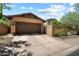 Exterior view of a home featuring a spacious driveway and a two car garage at 9262 E Desert Park Dr, Scottsdale, AZ 85255