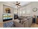 Comfortable living room with a fireplace, large TV, and sectional sofa at 9262 E Desert Park Dr, Scottsdale, AZ 85255