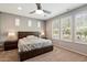 Bright main bedroom featuring a ceiling fan, plush carpet, and lots of natural light from two large windows at 9262 E Desert Park Dr, Scottsdale, AZ 85255