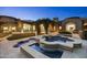 Stunning backyard with pool, water features, covered patio, and lush landscaping at 9290 E Thompson Peak Pkwy # 470, Scottsdale, AZ 85255