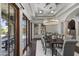 Bright dining room with coffered ceilings, a chandelier, and a wall of windows for natural light at 9290 E Thompson Peak Pkwy # 470, Scottsdale, AZ 85255