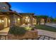 Beautiful stone-accented home featuring a covered patio, lush landscaping, and charming accents at 9290 E Thompson Peak Pkwy # 470, Scottsdale, AZ 85255