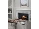 Close-up of a cozy fireplace with decorative mantel, built-in shelving, and ambient lighting at 9290 E Thompson Peak Pkwy # 470, Scottsdale, AZ 85255
