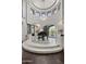 Grand foyer featuring a chandelier, piano, custom window seats, and elegant circular design at 9290 E Thompson Peak Pkwy # 470, Scottsdale, AZ 85255