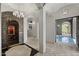 Elegant hallway with stone accents, leading to a wine cellar and a view of the outdoor pool, blending luxury and leisure at 9290 E Thompson Peak Pkwy # 470, Scottsdale, AZ 85255