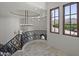 Upstairs hallway with curved wrought iron railing, chandelier and picturesque views at 9290 E Thompson Peak Pkwy # 470, Scottsdale, AZ 85255