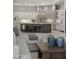 Gourmet kitchen with stone accent wall, custom cabinets and island seating, open to the living room, creating an inviting space at 9290 E Thompson Peak Pkwy # 470, Scottsdale, AZ 85255