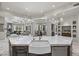 Spacious kitchen with a large marble island, a farmhouse sink, and stylish fixtures, with an open concept to living spaces at 9290 E Thompson Peak Pkwy # 470, Scottsdale, AZ 85255