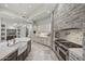 Gourmet kitchen with stone accent wall, tiled backsplash, custom cabinets, and professional grade stainless steel appliances at 9290 E Thompson Peak Pkwy # 470, Scottsdale, AZ 85255