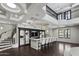 Open living area with a bar, seating, and staircase, perfect for entertaining, complete with modern finishes and design at 9290 E Thompson Peak Pkwy # 470, Scottsdale, AZ 85255