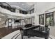 Spacious living area with grand piano, bar, staircase, and decorative wrought iron railings at 9290 E Thompson Peak Pkwy # 470, Scottsdale, AZ 85255