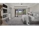 Bright main bedroom boasts private balcony access and cozy fireplace with custom stone design at 9290 E Thompson Peak Pkwy # 470, Scottsdale, AZ 85255