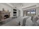 Main bedroom suite with fireplace, TV, and access to balcony with scenic views at 9290 E Thompson Peak Pkwy # 470, Scottsdale, AZ 85255