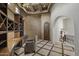 Intricate office space with beamed ceiling, custom built-ins, and arched doorway at 9290 E Thompson Peak Pkwy # 470, Scottsdale, AZ 85255
