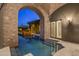 Tranquil outdoor pool with stone archway, surrounded by lush landscaping, creating a private oasis, perfect for relaxation at 9290 E Thompson Peak Pkwy # 470, Scottsdale, AZ 85255