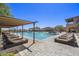Luxury pool area featuring a spacious pool, comfortable lounge chairs, and shaded seating areas for relaxation at 9290 E Thompson Peak Pkwy # 470, Scottsdale, AZ 85255