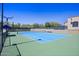 Bright and modern tennis court with a blue surface and well-maintained green surroundings at 9290 E Thompson Peak Pkwy # 470, Scottsdale, AZ 85255