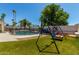 Resort style backyard with a sparkling pool, privacy fence and synthetic grass at 10029 S 44Th St, Phoenix, AZ 85044